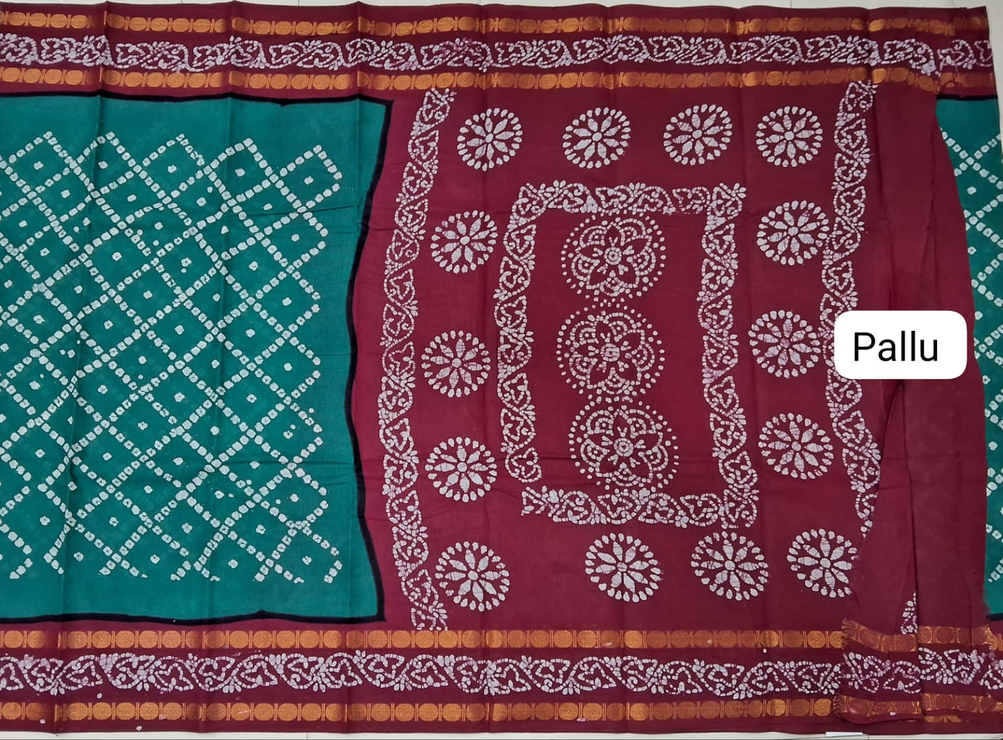 Sari with green and maroon pallu featuring white patterns