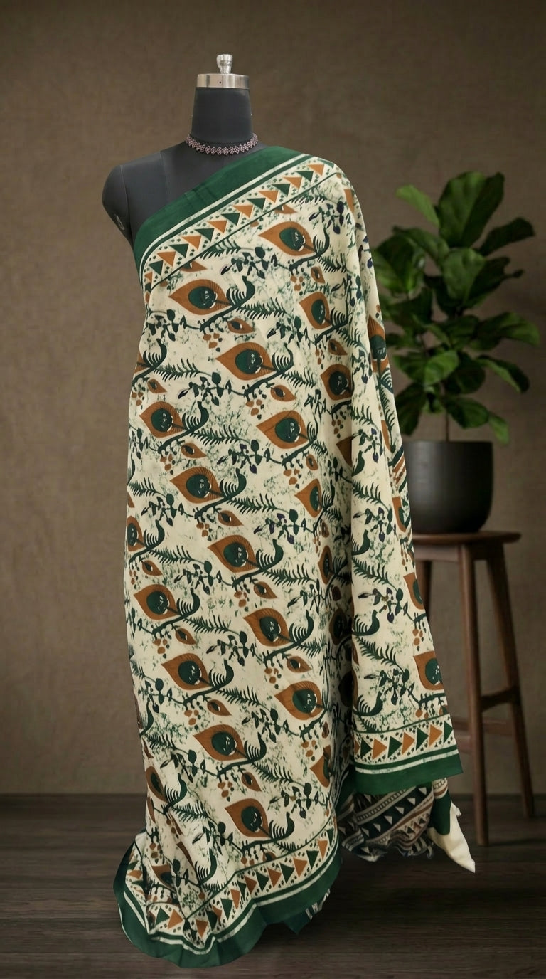 Beige Mulmul Cotton Saree with green and mustard yellow peacock feather printed