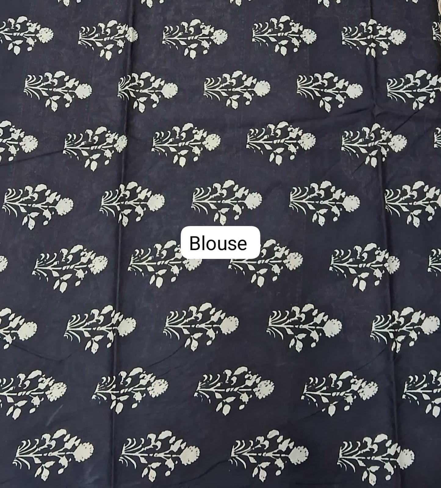 Navy blue fabric with white floral patterns and a 'Blouse' label.