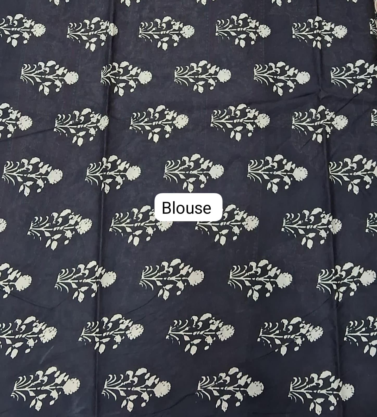 Navy blue fabric with white floral patterns and a 'Blouse' label.