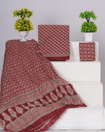Rust Red with white floral motis on the cotton dress material