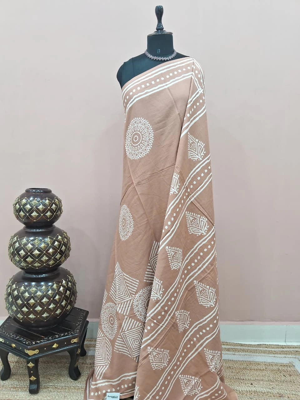 A beige soft cotton saree