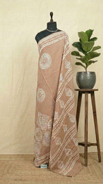 A beige soft cotton saree