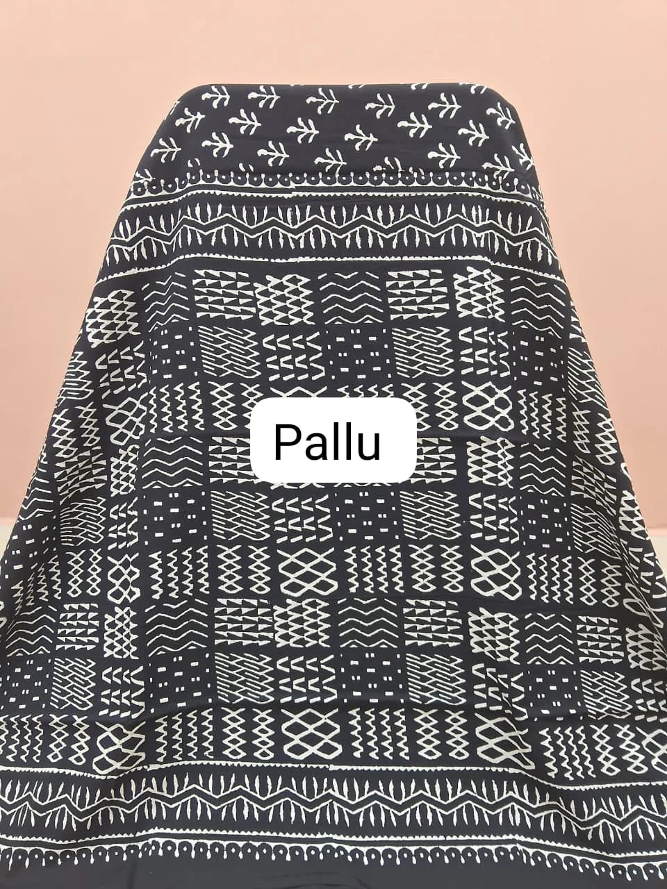 A graceful black soft cotton saree pallu