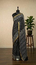 A striking black mulmul zari cotton saree
