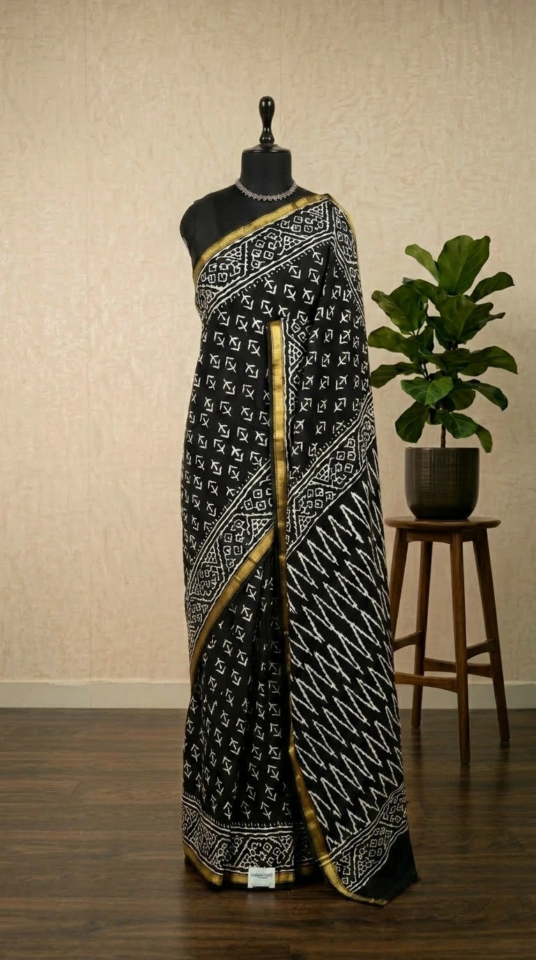 A striking black mulmul zari cotton saree