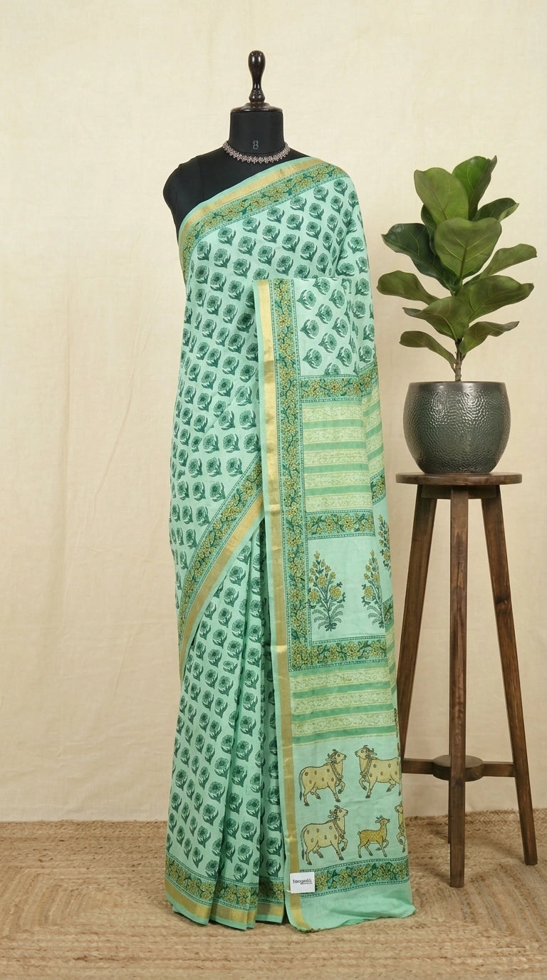 A mint green mulmul zari cotton saree