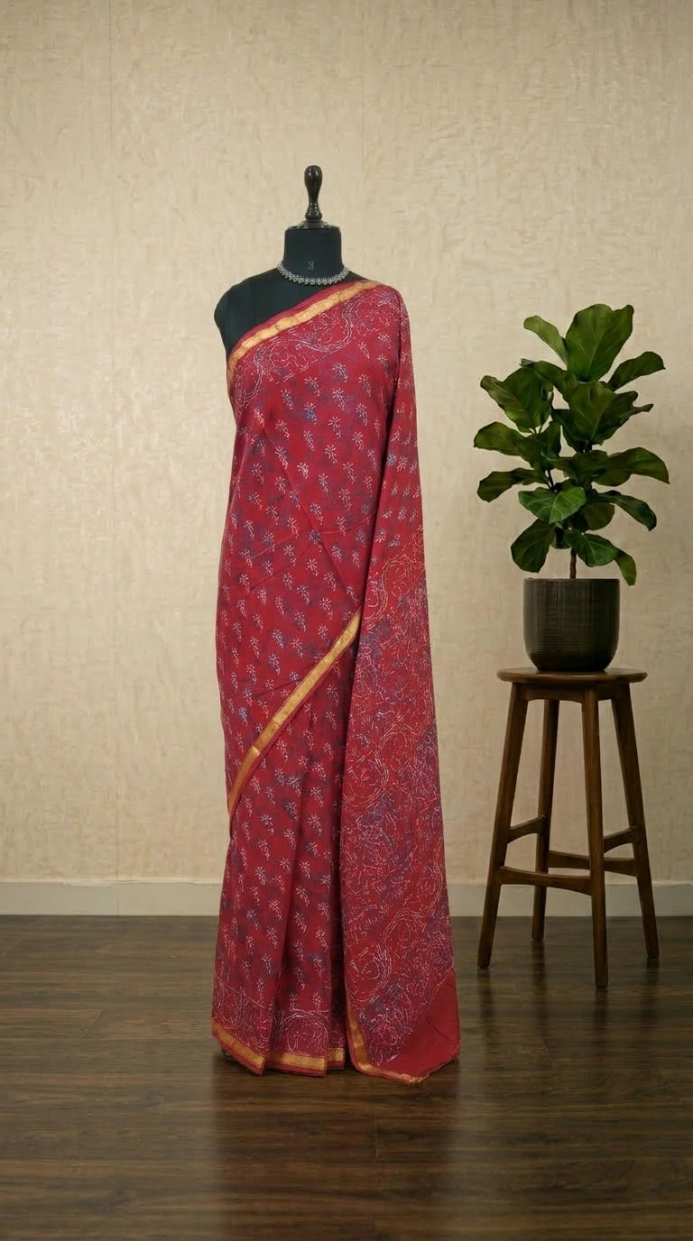 A vibrant tomato red mulmul zari cotton saree